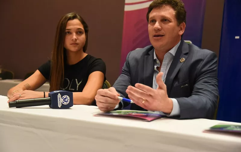 Conmebol's president Alejandro Dominguez(R) speaks before signing an agreement with female football star Venezuelan Deyna Castellanos at the Conmebol headquarters in Luque, Paraguay on December 19, 2017. - Castellanos was elected as ambassador of the South American Youth Festival to be held in Asuncion between February 9 and 17th, 2018. (Photo by NORBERTO DUARTE / AFP)