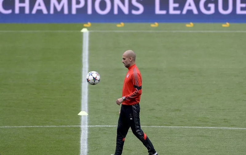 Bayern Munich's Spanish head coach Pep Guardiola eyes a ball during a training session at the camp nou stadium on May 5, 2015, on the eve of the UEFA Champions League semi-final first leg football match between FC Barcelona and FC Bayern Munich.   AFP PHOTO/ JOSEP LAGO