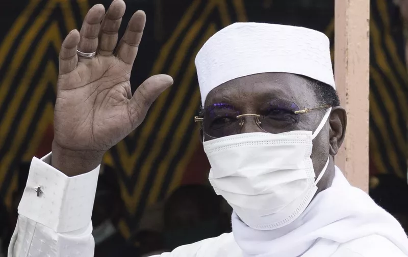 Chadian President Idriss Deby Itno greets a crowd of journalists and supporters as he arrives to casts his ballot at a polling station in N'djamena, on April 11, 2021. (Photo by MARCO LONGARI / AFP)