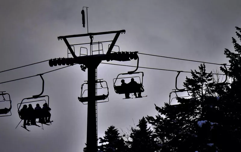Ski tourists use a chairlift in the ski resort of Seefeld, Austria, on January 30, 2021. (Photo by BARBARA GINDL / APA / AFP) / Austria OUT