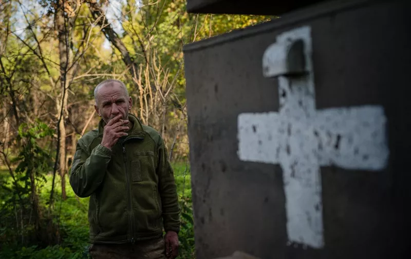 A Ukrainian serviceman smokes a cigarette at a position on the front line in the Donetsk region on October 19, 2022, amid Russian invasion of Ukraine. (Photo by Dimitar DILKOFF / AFP)
