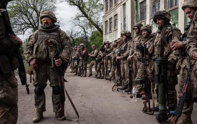 Ukrainian soldiers arrive at an abandoned building to rest and receive medical treatment after fighting on the front line for two months near Kramatorsk, eastern Ukraine, on April 30, 2022. - Russia invaded Ukraine on February 24, 2022. (Photo by Yasuyoshi CHIBA / AFP)