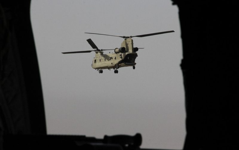 A US Chinook military helicopter carrying US Defense Secretary Jim Mattis flies towards NATO's Resolute Support mission in Kabul on September 7, 2018. - Mattis landed in Kabul on September 7 for an unannounced visit to war-torn Afghanistan, adding his weight to a flurry of diplomatic efforts to bring the Taliban to the negotiating table. (Photo by Thomas WATKINS / AFP)