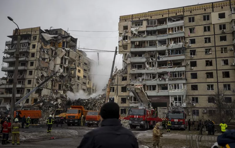 DNIPRO, UKRAINE - JANUARY 15: Firefighters conduct search and rescue operation in the rubbles of destroyed residential building after a Russian missile strike amid Russia-Ukraine war in Dnipro, Ukraine on January 15, 2023. The death toll rose to 14 including a 15-year-old. Mustafa Ciftci / Anadolu Agency (Photo by Mustafa Ciftci / ANADOLU AGENCY / Anadolu Agency via AFP)