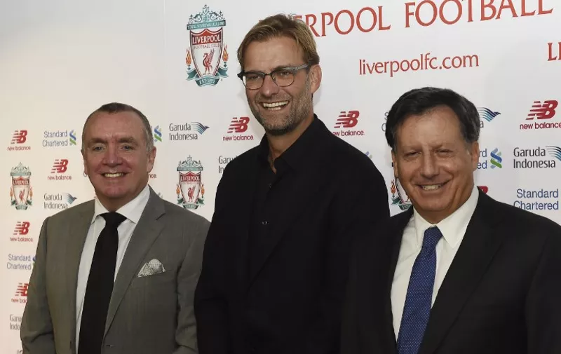 Liverpool's new German manager Jurgen Klopp (C) poses with Liverpool's managing director Ian Ayre (L) and chairman Tom Werner (R) at the start of a press conference to announce Klopp's appointment at Anfield in Liverpool, northwest England, on October 9, 2015. Klopp described his job as "the biggest challenge" in world football on October 9 following his appointment as the successor to Brendan Rodgers. Former Borussia Dortmund head coach Klopp, 48, was appointed on October 8 on a three-year contract following the dismissal of Rodgers, who was sacked October 4 after three and a half years at the club.  AFP PHOTO / PAUL ELLIS  

RESTRICTED TO EDITORIAL USE. No use with unauthorized audio, video, data, fixture lists, club/league logos or 'live' services. Online in-match use limited to 75 images, no video emulation. No use in betting, games or single club/league/player publications.
