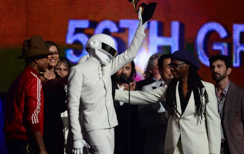 Winners for Best Record Of The Year "Get Lucky" Daft Punk, Pharrell Williams (L) and Nile Rodgers (R) celebrate on stage during the 56th Grammy Awards at the Staples Center in Los Angeles, California, January 26, 2014. AFP PHOTO FREDERIC J. BROWN
