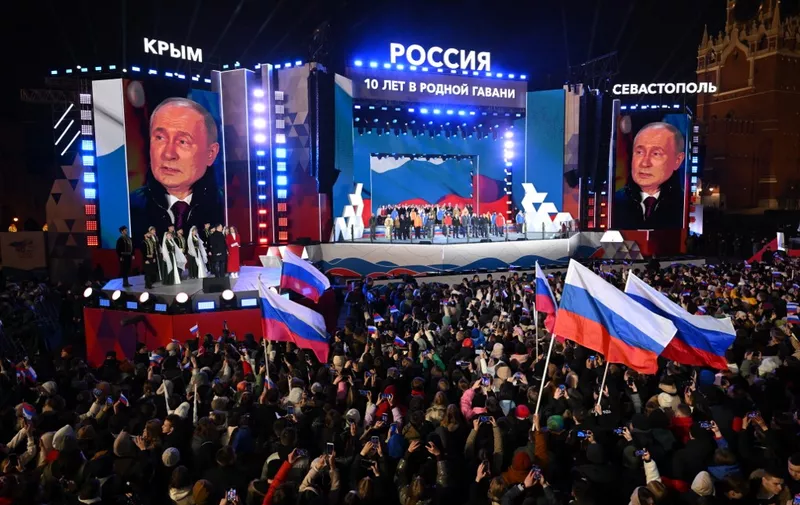 Russian President and presidential candidate Vladimir Putin addresses the crowd during a rally and a concert celebrating the 10th anniversary of Russia's annexation of Crimea at Red Square in Moscow on March 18, 2024. (Photo by NATALIA KOLESNIKOVA / AFP)