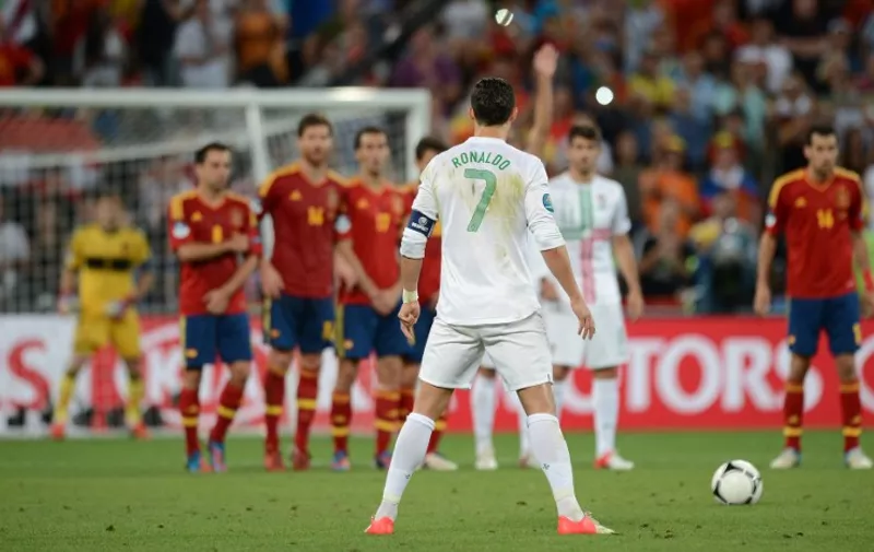 Portuguese forward Cristiano Ronaldo concentrates before a free kick during the Euro 2012 football championships semi-final match Portugal vs Spain on June 27, 2012 at the Donbass Arena in Donetsk. AFP PHOTO / JEFF PACHOUD / AFP / JEFF PACHOUD