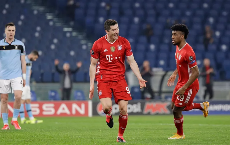 Bayern's Robert Lewandowski, center, celebrates after scoring his side's opening goal during the Champions League round of 16 first leg soccer match between Lazio and Bayern Munich at the Olympic stadium in Rome, Tuesday, Feb. 23, 2021. (AP Photo/Gregorio Borgia)
