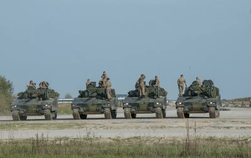 Soldiers on tanks take part in a joint military exercise of British, Estonian and Danish forces at the central training area of Tapa Base, Estonia, on October 1, 2020, as part of a series of exercises of the NATO EFP battlegroup. - The exercises are increasing in scale and will culminate with the battalion-level Furious Axe exercise starting mid-October 2020 at the Adai polygon in Latvia where the whole battlegroup will participate. (Photo by Raigo Pajula / AFP)