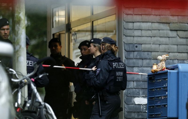 German police stand in front of a building where five children were found dead in an apartment on September 3, 2020 in the city of Solingen, western Germany. - A mother is suspected of killing her five children (who were one, two, three, six and eight years old) before attempting suicide by jumping in front of a train, police said. (Photo by LEON KUEGELER / AFP)