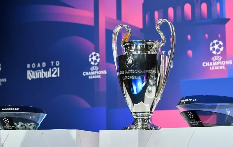 This handout photograph taken and released on December 14, 2020 by the Union of European Football Associations (UEFA) shows the trophy displayed on stage prior to the draw for the round of 16 of the UEFA Champions League football tournament at the UEFA headquarters in Nyon. - The draw for the round of 16 of the UEFA Champions League football tournament takes place virtually due to the new coronavirus pandemic. (Photo by Harold Cunningham / UEFA / AFP) / RESTRICTED TO EDITORIAL USE - MANDATORY CREDIT "AFP PHOTO / UEFA / HAROLD CUNNINGHAM" - NO MARKETING - NO ADVERTISING CAMPAIGNS - DISTRIBUTED AS A SERVICE TO CLIENTS