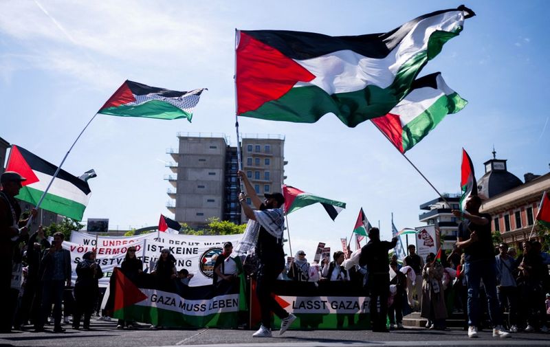Demonstrators wave the Palestinian flag during a pro-Palestinian demonstration at Columbus Square in Vienna, Austria on May 4, 2024, under the slogan 'Together for Palestine - ceasefire right now!', during the ongoing conflict between Israel and the militant group Hamas. (Photo by GEORG HOCHMUTH / APA / AFP) / Austria OUT
