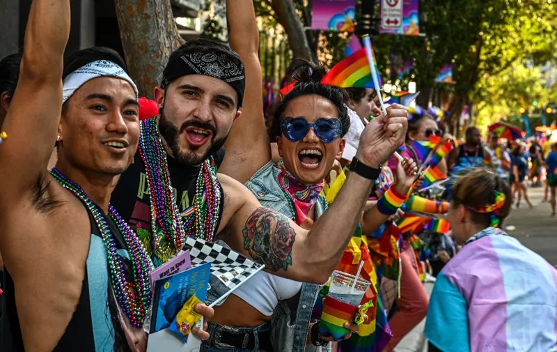 People attend a Pride Parade, in Orlando, Florida on October 15, 2022. (Photo by Giorgio VIERA / AFP)