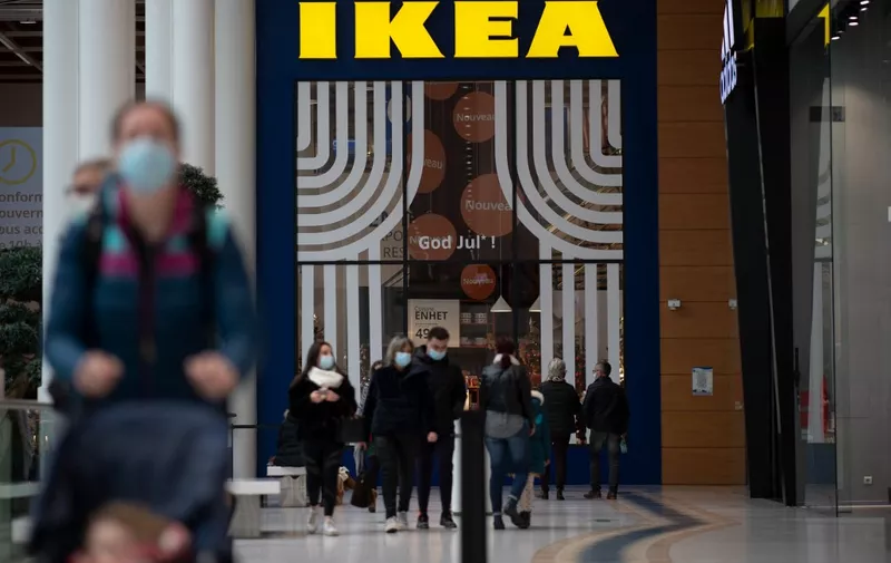 People walk in front of the entrance of a Scandivanian furniture chain store Ikea, on January 13, 2021 in Saint-Herblain, outside the city of Nantes. (Photo by LOIC VENANCE / AFP)