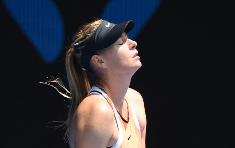 Russia's Maria Sharapova reacts during her women's singles match against Serena Williams of the US on day nine of the 2016 Australian Open tennis tournament in Melbourne on January 26, 2016. AFP PHOTO / WILLIAM WEST-- IMAGE RESTRICTED TO EDITORIAL USE - STRICTLY NO COMMERCIAL USE / AFP / WILLIAM WEST