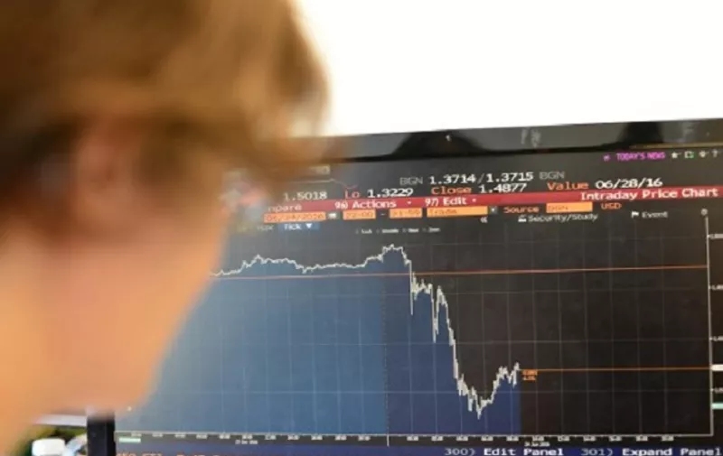 A woman poses looking at a chart showing the drop in the pound (Sterling) against the US Dollar in London on June 24, 2016 after Britain voted to leave the EU. 
The Bank of England will take "all necessary steps" to ensure monetary and financial stability after Britain's decision to leave the European Union, it said on June 24. The pound collapsed to a 31-year low and there was pandemonium on currency, equity and oil markets on June 24 as Britain voted to leave the European Union, fuelling a wave of global uncertainty. / AFP PHOTO / Daniel SORABJI