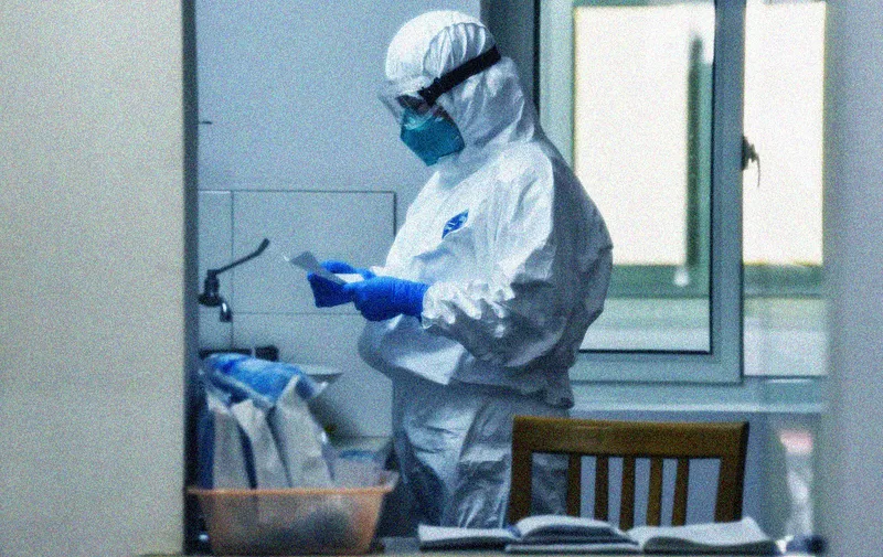 A medical staff wearing protective clothes is seen in the fever clinic of a hospital in Shanghai on February 27, 2020. - China reported 29 more deaths on February 27 from the new coronavirus epidemic, the lowest daily figure in almost a month, and the number of fresh infections rose slightly. (Photo by Hector RETAMAL / AFP)