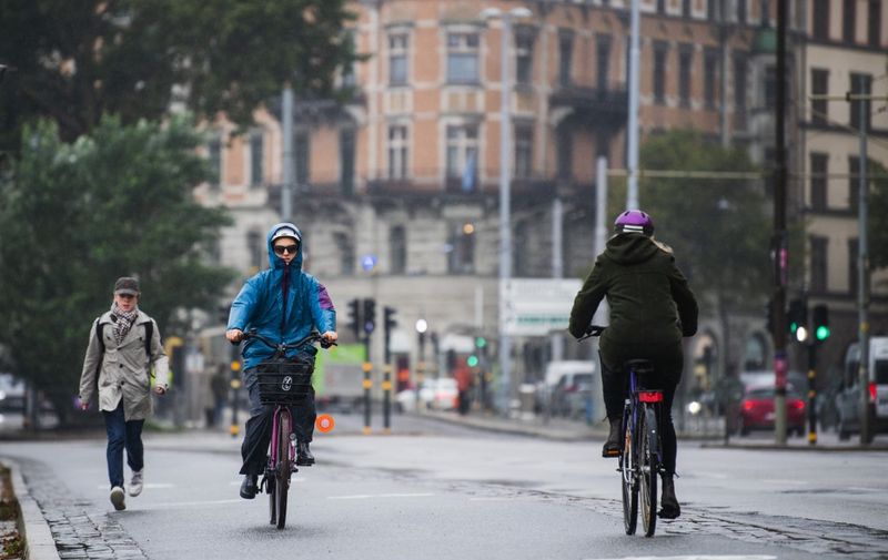 People ride their bikes in Stockholm on October 22, 2020, during the novel coronavirus COVID-19 pandemic. (Photo by Jonathan NACKSTRAND / AFP)