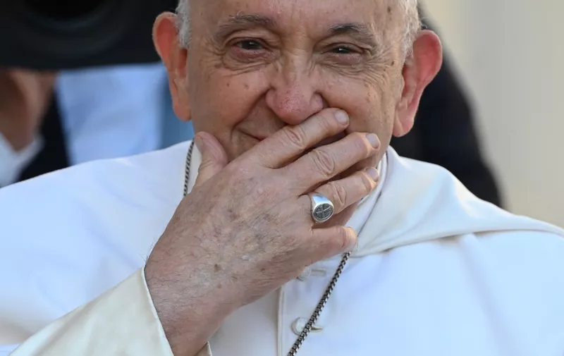 Pope Francis smiles as he arrives on the popemobile for the weekly general audience on September 27, 2023 at St Peter's square in The Vatican. (Photo by Filippo MONTEFORTE / AFP)