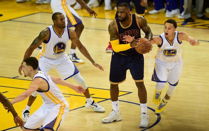 Stephen Curry of the Golden State Warriors steals the ball from LeBron James of the Cleveland Cavaliers in overtime of Game 1 of the 2015 NBA Finals in Oakland, California, on June 4, 2015. The Warriors defeated the Cavaliers 108-100 in overtime.  AFP PHOTO / FREDERIC J. BROWN