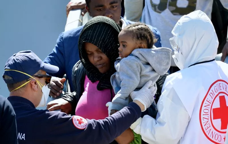 TOPSHOTS Rescued migrants disembark from the Italian Navy vessel Bettica after arriving in the Sicilian harbour of Augusta on April 22, 2015 . European governments came under increasing pressure to tackle the Mediterranean&#8217;s migrant crisis ahead of an emergency summit, as harrowing details emerged of the fate of hundreds who died in the latest tragedy. [&hellip;]