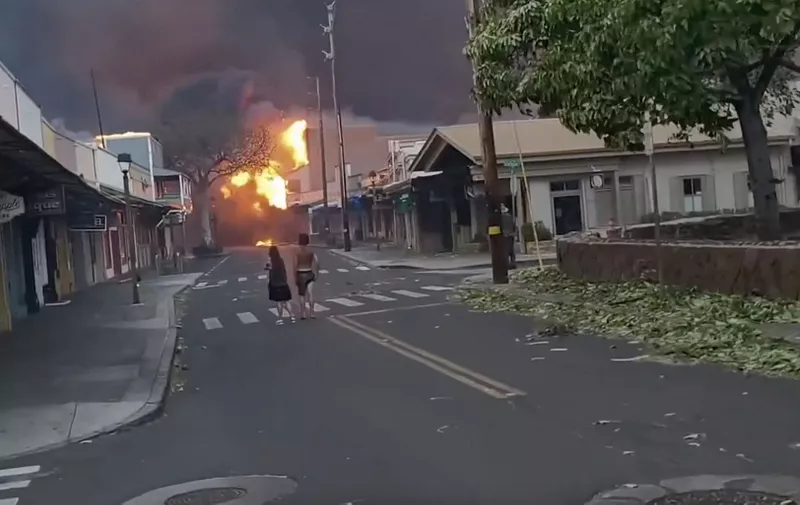At least 36 people have died as fast-moving wildfires rage across the Hawaiian island of Maui, officials say., Residents in the Upcountry and Lahaina areas of West Maui have been forced to evacuate, with some escaping the smoke and flames by running into the ocean. Maui County officials said Tuesday that the U.S. Coast Guard was working to rescue those residents, and transported them to “safe areas.”, Maui County Mayor Richard T. Bissen issued an emergency proclamation on Tuesday, and multiple evacuation orders were in place. The county confirmed damage to structures, but did not have details on the extent of the damage., Images from video footage show the fire raging amid strong winds in the downtown business district of Lahaina - the island's main tourist area - late on Tuesday (August 8) as people watch on in horror., “Today was a devastating day in Lahaina,” Dickar said. “This is the main business district. A lot of homes nearby burned as well. Tomorrow, the sun will rise, and, through the smoke, we will all find our way. Please stay safe and help your neighbors.”, Maui County said the cause of the fires is under investigation., CREDIT A Dickar/LOCAL NEWS X /TMX/MEGA.
10 Aug 2023,Image: 795863212, License: Rights-managed, Restrictions: World Rights, Model Release: no, Pictured: Images from video footage show the fire raging amid strong winds in the downtown business district of Lahaina - the island's main tourist area - late on Tuesday (August 8) as people watch on in horror