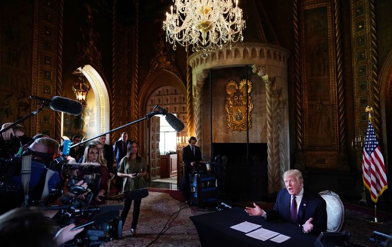 US President Donald Trump speaks to the press after talking to members of the military via teleconference from his Mar-a-Lago resort in Palm Beach, Florida, on Thanksgiving Day, November 22, 2018. (Photo by Mandel NGAN / AFP)