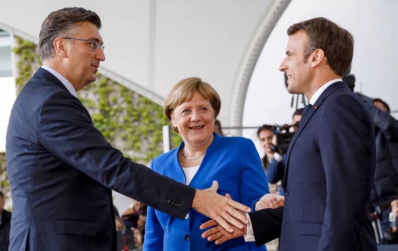 BERLIN, GERMANY - APRIL 29: German Chancellor Angela Merkel (C) and French President Emmanuel Macron (R) greet Croatian Prime Minister Andrej Plenkovic (L) upon his arrival at the Chancellery for a conference on western Balkan nations on April 29, 2019 in Berlin, Germany. German Chancellor Angela Merkel and French President Emmanuel Macron are hosting the conference that includes the leaders of North Macedonia, Albania, Croatia, Bosnia-Herzegovina, Serbia, Kosovo, Montenegro and Slovenia. (Photo by Carsten Koall/Getty Images)