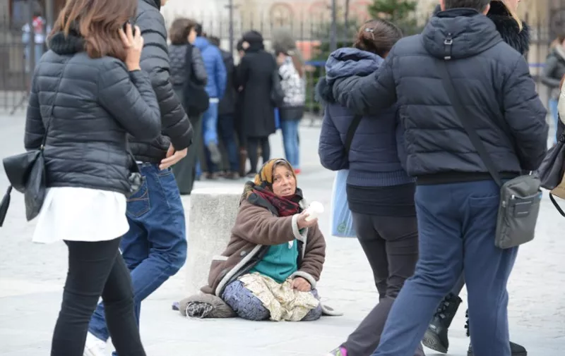 Female beggar sitting near Notre Dame sitting near Notre Dame in Paris, Dec. 13, 2015.