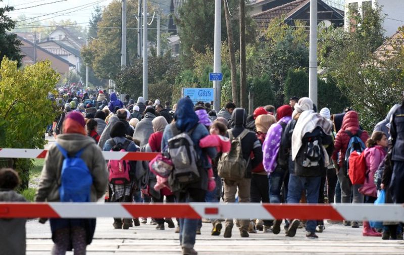 Migrants and refugees walk to the Croatian-Slovenian border after disembarking from a train on October 20, 2015 in Kljuc Brdovecki. Tensions have built along the migrant trail after Hungary shut key borders with Serbia and Croatia to migrants with razor wire -- pushing the flow west to Slovenia, which in turn has also limited arrivals, along with Croatia. The moves have left thousands of people stranded in wet and freezing weather at Croatia's frontier with Serbia, after they travelled up through Greece and Macedonia. AFP PHOTO / STRINGER