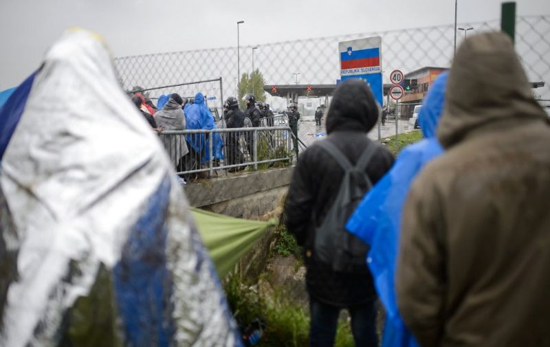 Migrants wait to be allowed to enter Slovenia, at the Croatian-Slovenian border in Trnovec, on October 19, 2015. Slovenian authorities said on October 19, 2015 they had refused to let in more than 1,000 migrants arriving from Croatia after a daily quota had been reached, stoking fears of a new human bottleneck on the western Balkan route. AFP PHOTO / JURE MAKOVEC