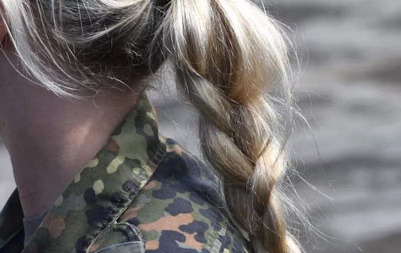 A female soldier of the German armed forces Bundeswehr is pictured during an educational practice of the "Very High Readiness Joint Task Force" (VJTF) as part of the NATO tank unit at the military training area in Munster, northern Germany, on May 20, 2019. (Photo by PATRIK STOLLARZ / AFP)