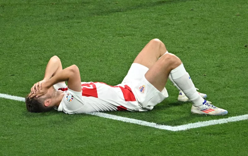 Soccer Football - Euro 2024 - Group B - Croatia v Italy - Leipzig Stadium, Leipzig, Germany - June 24, 2024  Croatia's Josip Stanisic looks dejected after the match REUTERS/Annegret Hilse