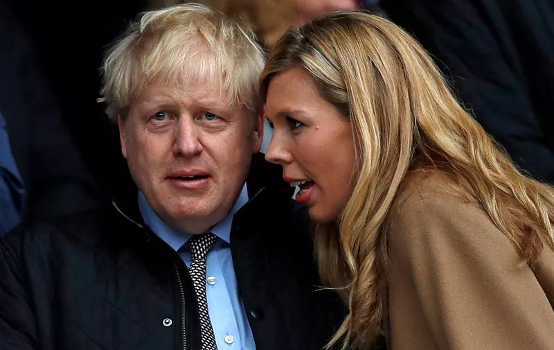 (FILES) In this file photo taken on March 08, 2020 (FILES) In this file photo taken on March 07, 2020 Britain's Prime Minister Boris Johnson (2R) with his partner Carrie Symonds (R) attend the Six Nations international rugby union match between England and Wales at the Twickenham, west London, on March 7, 2020. - Johnson married his fiancee Carrie Symonds married in a "secret ceremony" on May 29, 2021, UK media reports said. (Photo by ADRIAN DENNIS / AFP)