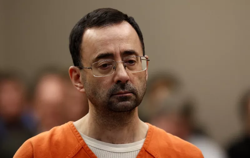 (FILES) Former Michigan State University and USA Gymnastics doctor Larry Nassar appears at Ingham County Circuit Court in Lansing, Michigan, on November 22, 2017. Larry Nassar, the former USA Gymnastics team doctor convicted of sexually assaulting hundreds of athletes, was in stable condition on July 10, 2023, after being stabbed multiple times by another inmate, a prison union official said. Nassar, 59, was attacked on the afternoon of July 9, 2023, at the federal USP Coleman II prison in Sumterville, Florida, where he is serving his sentence, Joe Rojas, the president of the local correctional officers union, told AFP. (Photo by JEFF KOWALSKY / AFP)