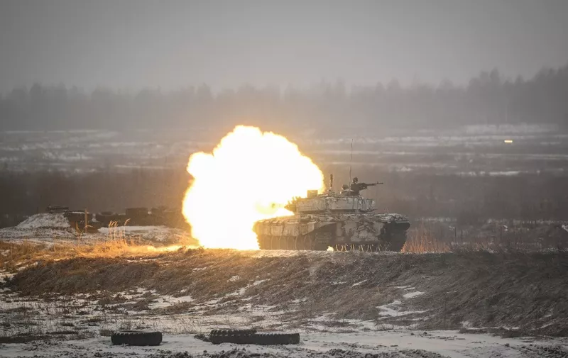 A tank fires during a combat training of cadets of the Military Academy of the Republic of Belarus at the Belaya Luzha training centre outside the town of Zhodino in the Minsk region on February 17, 2023. (Photo by Natalia KOLESNIKOVA / AFP)