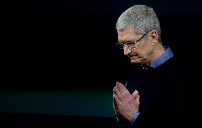 Apple CEO Tim Cook gestures during a media event at Apple headquarters in Cupertino, California on March 21, 2016.
Apple on Monday unveiled a new iPhone with a four-inch screen, aiming to reach consumers looking for a handset that is more affordable and compact than its flagship models. / AFP PHOTO / Josh Edelson
