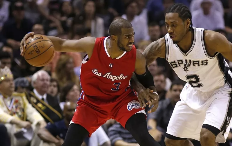 SAN ANTONIO, TX &#8211; APRIL 24: Chris Paul #3 of the Los Angeles Clippers holds the ball away from Kawhi Leonard #2 of the San Antonio Spurs in Game Three during the first round of the 2015 NBA Playoffs at the AT&amp;T Center on April 24, 2015 in San Antonio, Texas. NOTE TO USER: User [&hellip;]