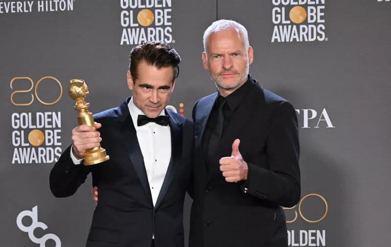 Irish actor Colin Farrell (L) and British-Irish director Martin McDonagh pose with the award for Best Musical/Comedy Series for "The Banshees of Inisherin" in the press room during the 80th annual Golden Globe Awards at The Beverly Hilton hotel in Beverly Hills, California, on January 10, 2023. (Photo by Frederic J. Brown / AFP)