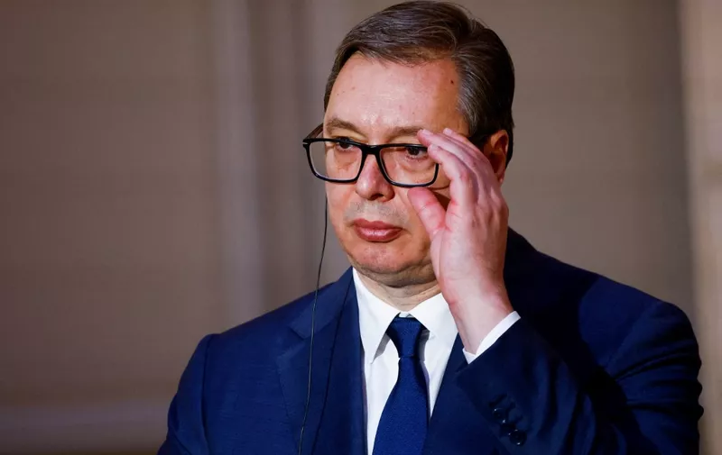Serbia's President Aleksandar Vucic adjusts his glasses during a joint statement with France's President ahead of a working dinner at the presidential Elysee Palace in Paris on April 8, 2024. The two heads of state are expected to discuss issues including Serbia's European integration and relations between Belgrade and Kosovo. (Photo by Sarah Meyssonnier / POOL / AFP)