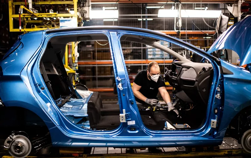 (FILES) This file photo taken on May 6, 2020 in Flins-sur-Seine, shows the assembly line that produces both the electric vehicle Renault Zoe and the hybrid vehicle Nissan Micra, the largest Renault production site in France. - France is preparing a package of measures to shore up automakers stung by the coronavirus crisis, including subsidies to encourage purchases of electric vehicles, Finance Minister Bruno Le Maire said May 18, 2020. (Photo by Martin BUREAU / AFP)
