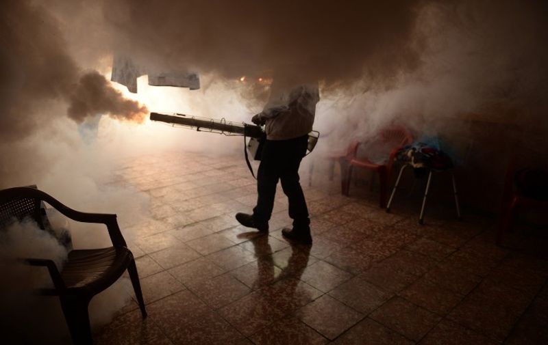 A Health Ministry employee fumigates a home against the Aedes aegypti mosquito to prevent the spread of the Zika virus in Soyapango, six km east of San Salvador, on January 21, 2016. Health authorities have issued a national alert against the Aedes Aegypti mosquito, because of the link between the Zika virus and microcephaly and Guillain-Barré Syndrome in fetuses. AFP PHOTO/Marvin RECINOS / AFP / Marvin RECINOS