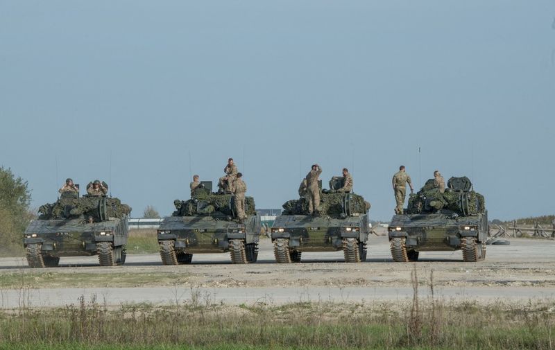 Soldiers on tanks take part in a joint military exercise of British, Estonian and Danish forces at the central training area of Tapa Base, Estonia, on October 1, 2020, as part of a series of exercises of the NATO EFP battlegroup. - The exercises are increasing in scale and will culminate with the battalion-level Furious Axe exercise starting mid-October 2020 at the Adai polygon in Latvia where the whole battlegroup will participate. (Photo by Raigo Pajula / AFP)