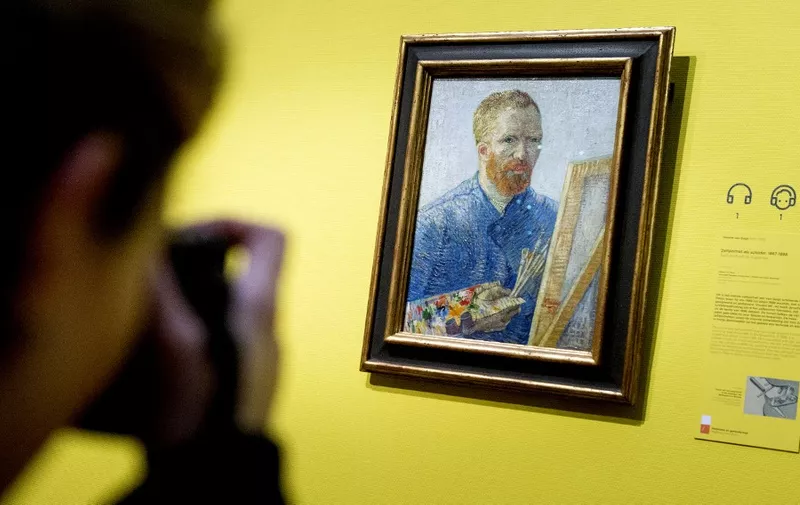 A visitor in the Van Gogh Museum Amsterdam takes a picture of the famous Dutch painter's self portrait with easel dated from 1888 prior to the reopening of the museum, in Amsterdam on May 1, 2013. According to media information the museum was renovated for several months with more than 10,000 square meters of walls painted and about 2,300 square meters of parquet floor laid. Amsterdam's Van Gogh Museum reopened its doors to the public with a stunning new display of some of the Dutch master's greatest works, completing a trio of renovations of the city's most famous museums. AFP PHOTO / ANP -KOEN VAN WEEL = netherlands out 
RESTRICTED TO EDITORIAL USE, MANDATORY CREDIT OF THE ARTIST, TO ILLUSTRATE THE EVENT AS SPECIFIED IN THE CAPTION (Photo by Koen van Weel / ANP / AFP)