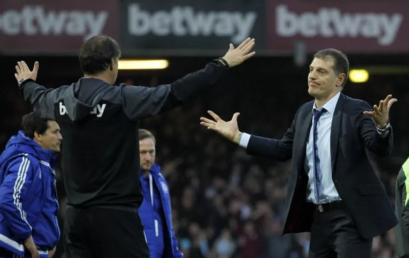 West Ham United's Croatian manager Slaven Bilic (R) reacts after his team win 2-1 during the English Premier League football match between West Ham United and Chelsea at The Boleyn Ground in Upton Park, east London on October 24, 2015. AFP PHOTO / IAN KINGTON

RESTRICTED TO EDITORIAL USE. No use with unauthorized audio, video, data, fixture lists, club/league logos or 'live' services. Online in-match use limited to 75 images, no video emulation. No use in betting, games or single club/league/player publications.