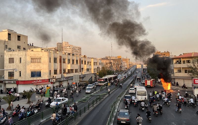 A picture obtained by AFP outside Iran, reportedly shows a motorcycle on fire in the capital Tehran, on October 8, 2022. - Iran has been torn by the biggest wave of social unrest in almost three years, which has seen protesters, including university students and even young schoolgirls chant "Woman, Life, Freedom". (Photo by AFP)
