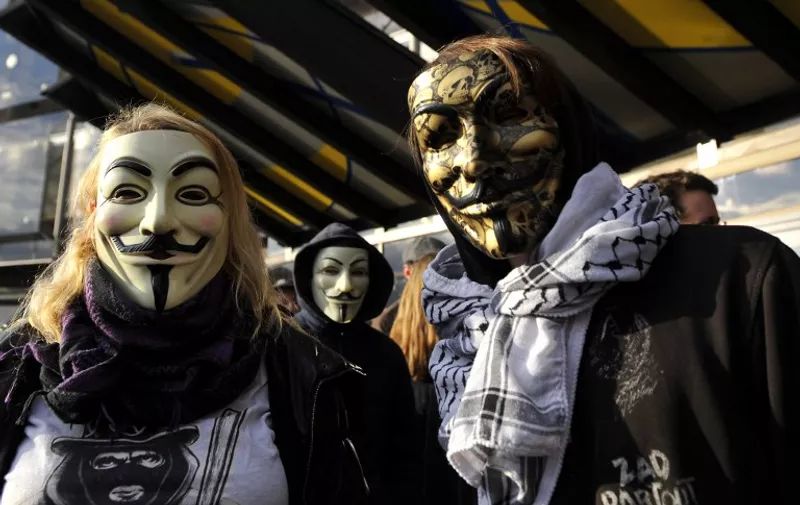 People wearing Guy Fawkes masks demonstrate prior to the trial of three "Anonymous" for their alleged involvement in cyber attacks targetting institutional websites, on November 9, 2015 in front of Nancy's courthouse, eastern France. AFP PHOTO/JEAN-CHRISTOPHE VERHAEGEN / AFP / JEAN-CHRISTOPHE VERHAEGEN