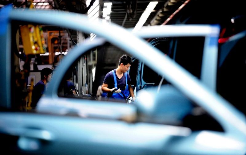 This picture taken on July 8, 2014 shows labourers assembling cars in a workshop at the faculties of HuaChen Group Auto in Shenyang, northeast China's Liaoning province. Chinese growth failed to accelerate in the second quarter despite government stimulus measures, an AFP survey predicts, with the world's second-largest economy forecast to record its worst annual performance in 24 years.  CHINA OUT     AFP PHOTO / AFP PHOTO / STR