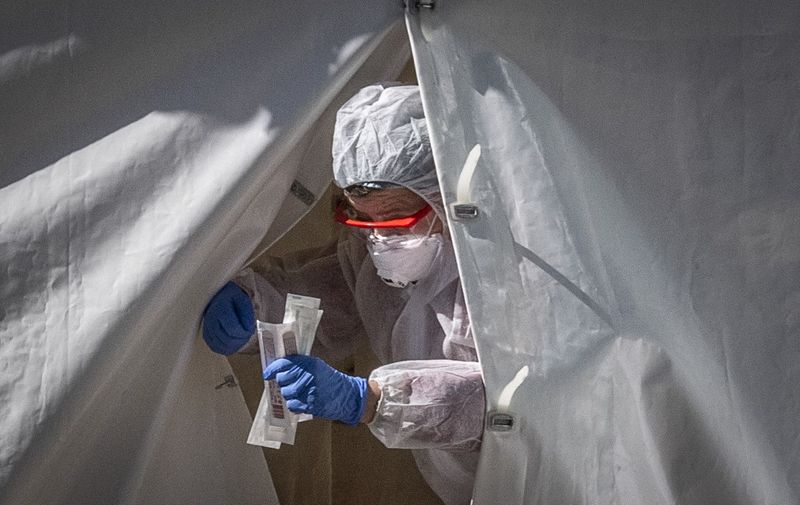 A medical staff gets out from a tent of a testing point for the COVID-19 coronavirus in central Moscow on May 2, 2020. - Russia on Saturday reported its largest increase in coronavirus cases with the new infections rising by nearly 10,000 in a single day. (Photo by Yuri KADOBNOV / AFP)